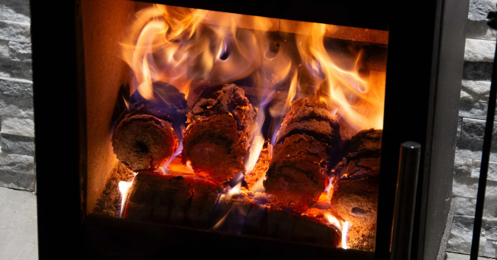 coffee husks logs with a gentle colourful flame